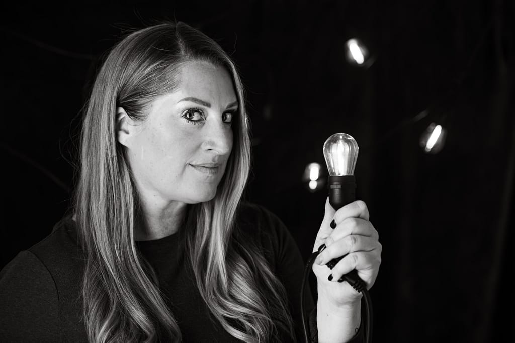 Anne Gillaspie holding a light bulb to inspire and create 
