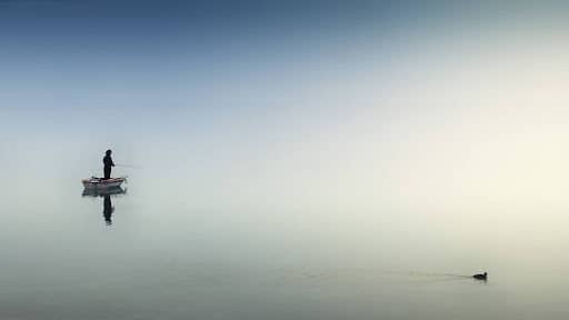 person in a boat in an endless body of water symbolizes floating aimlessly and needing to find a work-life balance Fix & Form Strategic Branding Agency Denver Colorado