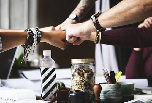 A group of fists meeting in a circle symbolizing Leading boldly Fix and Form Strategic branding agency, Denver, CO